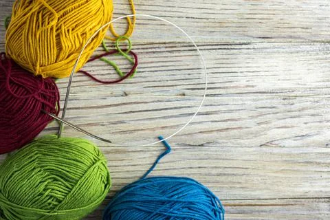 Multi-colored threads for knitting and knitting needles. Selection of colorful Foto stock