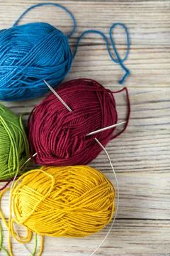 Multi-colored threads for knitting and knitting needles. Selection of colorful Stock Photos