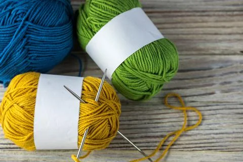 Multi-colored threads for knitting and knitting needles. Selection of colorful Stock Photos