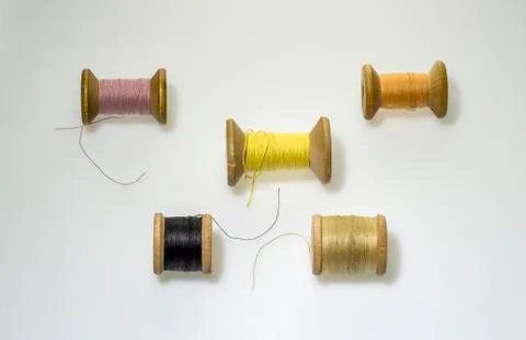 Multi-colored threads on old coils Stock Photos