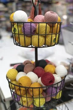 Multi-colored threads on the shop window. Hobby and needlework shop with a Stock Photos