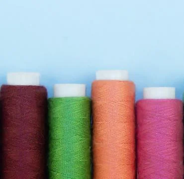 Multi-colored threads in spools, sewing kit. Close-up Stock Photos