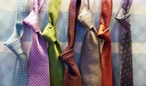 Multi-colored ties in a shop window. Stock Photos