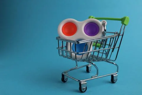 The multi-colored toy will wash popit the simple dimple in the shopping cart Stock Photos