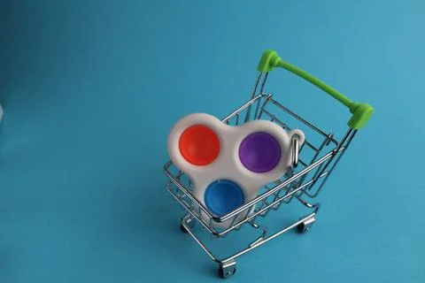 The multi-colored toy will wash popit the simple dimple in the shopping cart Stock Photos