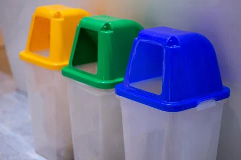 Multi-colored trash bins used to separate waste Stock Photos
