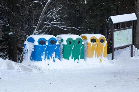 Multi-colored trash cans for recycling and household waste, in the winter in  Stock Photos