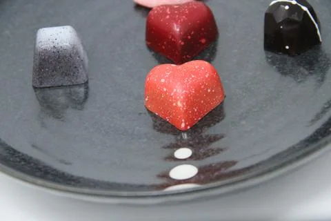 Multi-Colored Truffle Candies Close-Up on an Artsy Black Plate Stock Photos