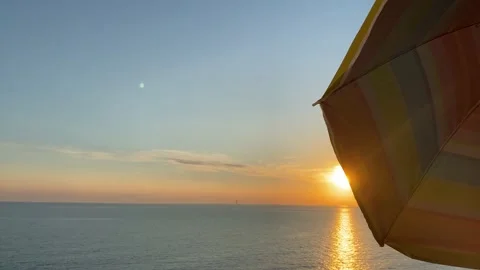 Multi-colored umbrella on the background of the sea and sunset 库存影片 161297902