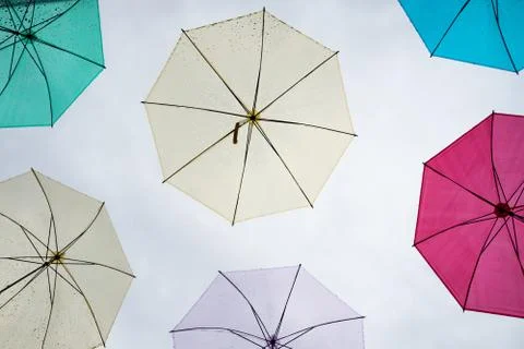 Multi-colored umbrellas in the sky on heavy rainy days Stock Photos
