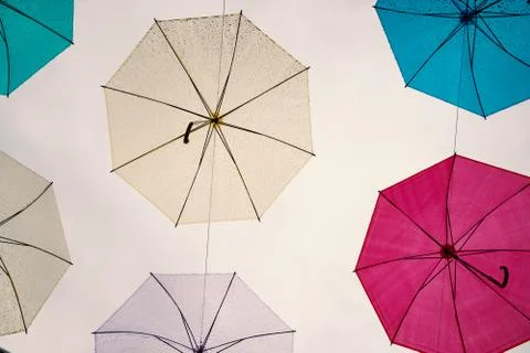 Multi-colored umbrellas in the sky on heavy rainy days Stock Photos