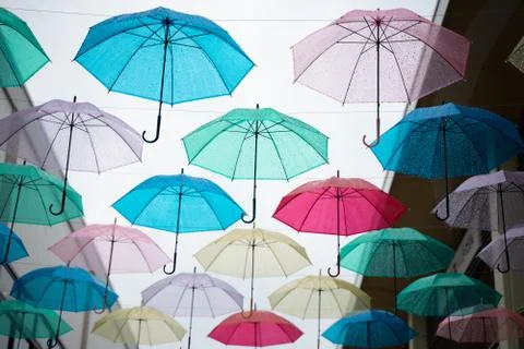 Multi-colored umbrellas in the sky on heavy rainy days Stock Photos