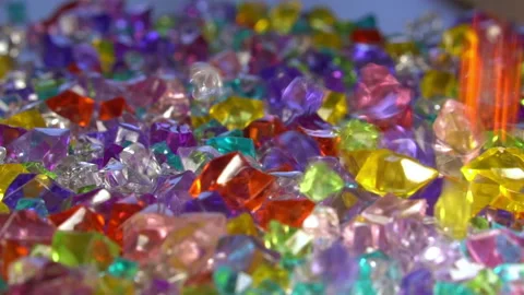 Multi-colored variety, Transparent, colored, plastic pebbles fall on the surface Stock Footage 219888739