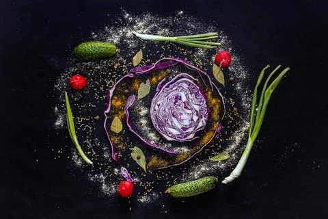 Multi-colored vegetables with spices on a black background close-up 스톡 사진