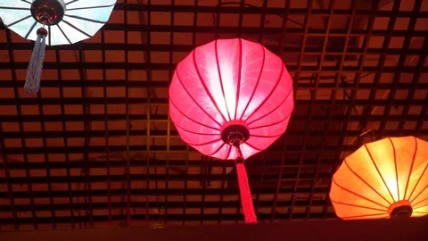Multi-colored vietnamese lanterns hang and glow 動画素材 124879381