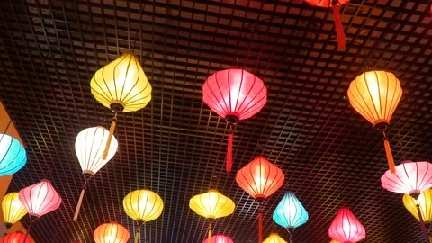 Multi-colored vietnamese lanterns hang and glow 库存影片 124879432