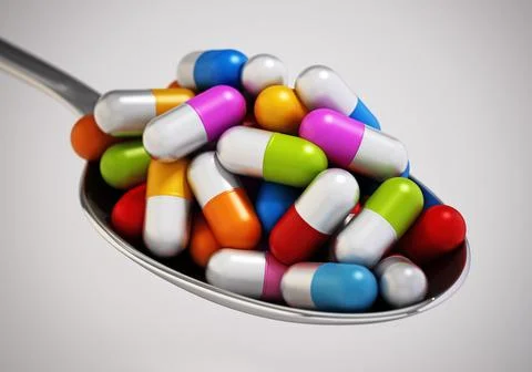 Multi colored vitamin pills inside a metal spoon. 3D illustration Stock Illustration