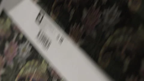 Multi-colored waste paper moves through machine into shop Stock Footage 295152375