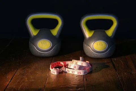 Multi-colored weights and dumbbells at the fitness center Stock Photos