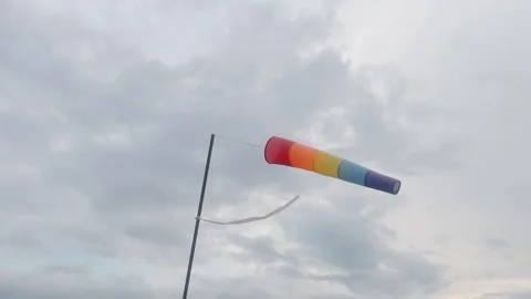 The multi-colored wind indicator is strongly developed against the background of Stock Footage 250496340