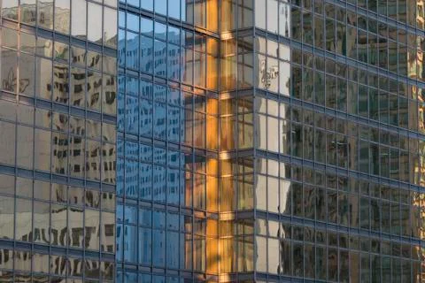 Multi-colored windows of a skyscraper Stock Photos