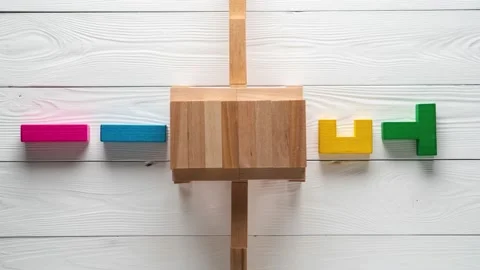 Multi-colored wooden blocks pass through portal and change their shape. Stock Footage 146394194