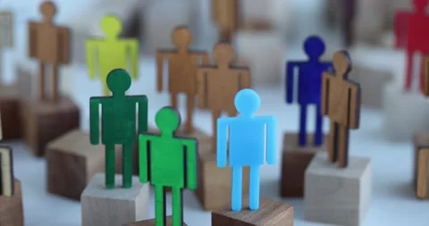 Multi-colored wooden figurines in crowd of identical ones closeup Video stock 171069104