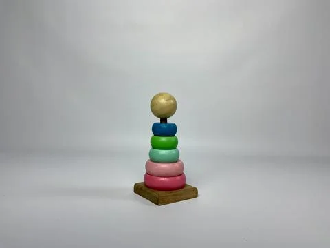 Multi-colored wooden ring stacker toy isolated on white. Traditional educational Stock Photos