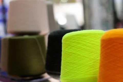 Multi-colored wool yarn cones for textile industry Stock Photos