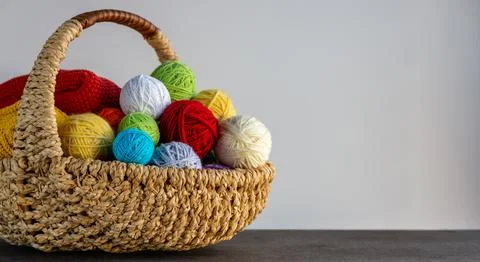 Multi-colored yarn in a basket on the table. Knitting concept. Hobby. Bright  Stock Photos