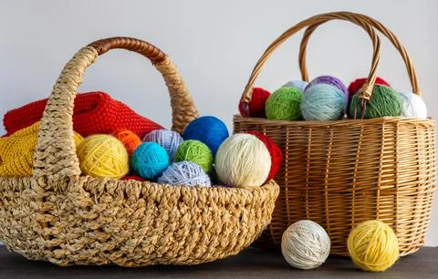 Multi-colored yarn in a basket on the table. Knitting concept. Hobby. Bright  Stock Photos