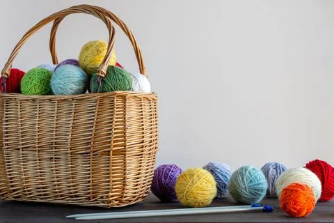 Multi-colored yarn in a basket on the table. Knitting concept. Hobby. Bright  Stock Photos
