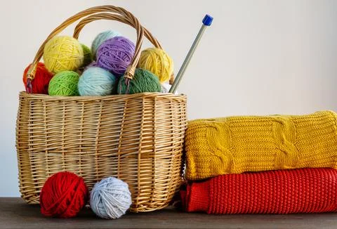Multi-colored yarn in a basket on the table. Knitting concept. Hobby. Bright  Stock Photos