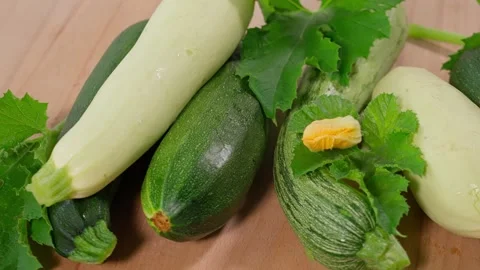 Multi-colored zucchini yellow, green, white, striped on the table close-up Stock Footage 270151404