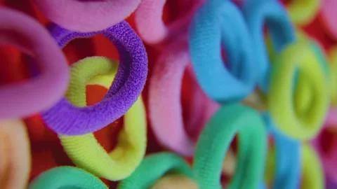 Multi colors rubber bands red background 4k vertical footage Stock Footage 301862026