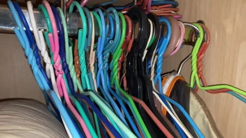 Multi colour cloth hangers close up shot inside closet Stock Footage 248311648