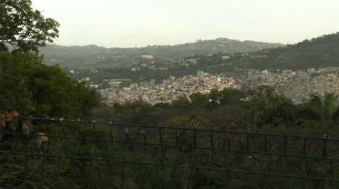 Multi-colour homes spill down hillside, big zoom in Stock Footage 39454537