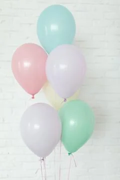Multi coloured baloons on background of white wall Stock Photos
