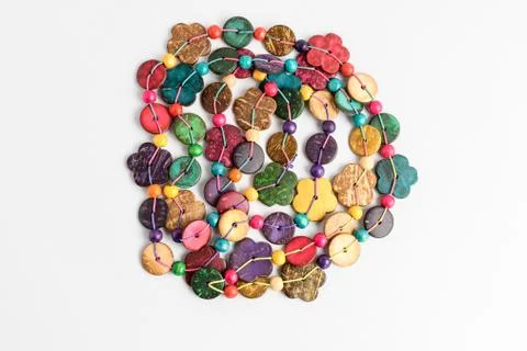 Multi coloured beads hand made from coconut shell, flowers and rounded pieces Stock Photos