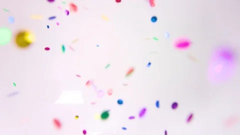 Multi coloured confetti falling on a white background Stockbeeldmateriaal 85463496