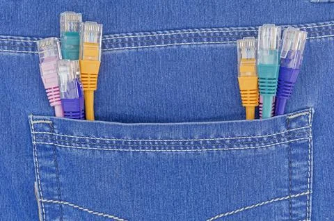 Multi coloured ethernet network cables in blue jeans pocket Stock Photos