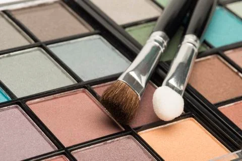 Multi coloured eye shadow palette with brushes Stock Photos