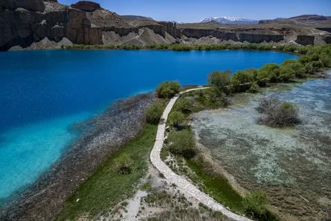 Multi coloured lakes surrounded by mountains and greenery in Afghanistan's Stock Photos