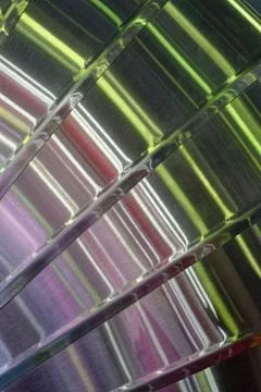 Multi-coloured light reflections on a curved surface made of brushed stainl.. Stock Photos