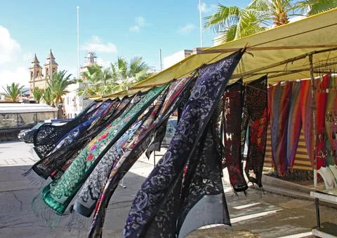 Multi coloured patterned silk scarves blowing in the breeze on a market stall Stock Photos