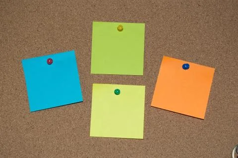 Multi Coloured Post it Notes on a Cork Board Stock Photos
