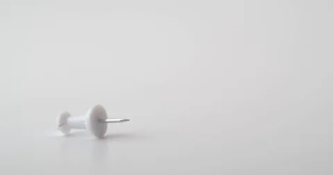 Multi-coloured push pins dropping into frame Stock Footage 117350150