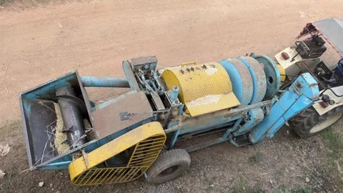 Multi-crop agricultural thresher machine parked in a rural field Stock-Footage 331449740