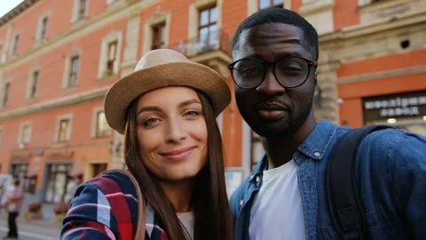 Multi-ethic cute young couple in love taking selfie on background of beautiful Stock Footage 81837575