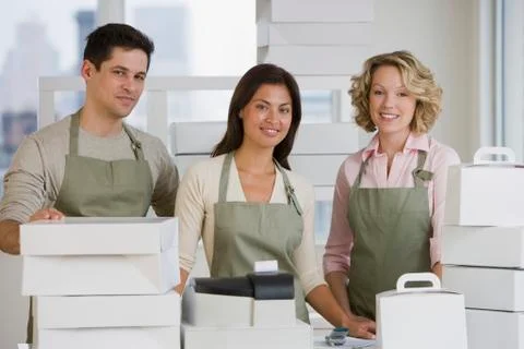 Multi-ethnic bakery workers behind counter Stock Photos